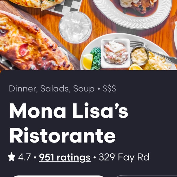 Overhead view of various Italian dishes including calzone, salad, and a meat entree on a wooden table.